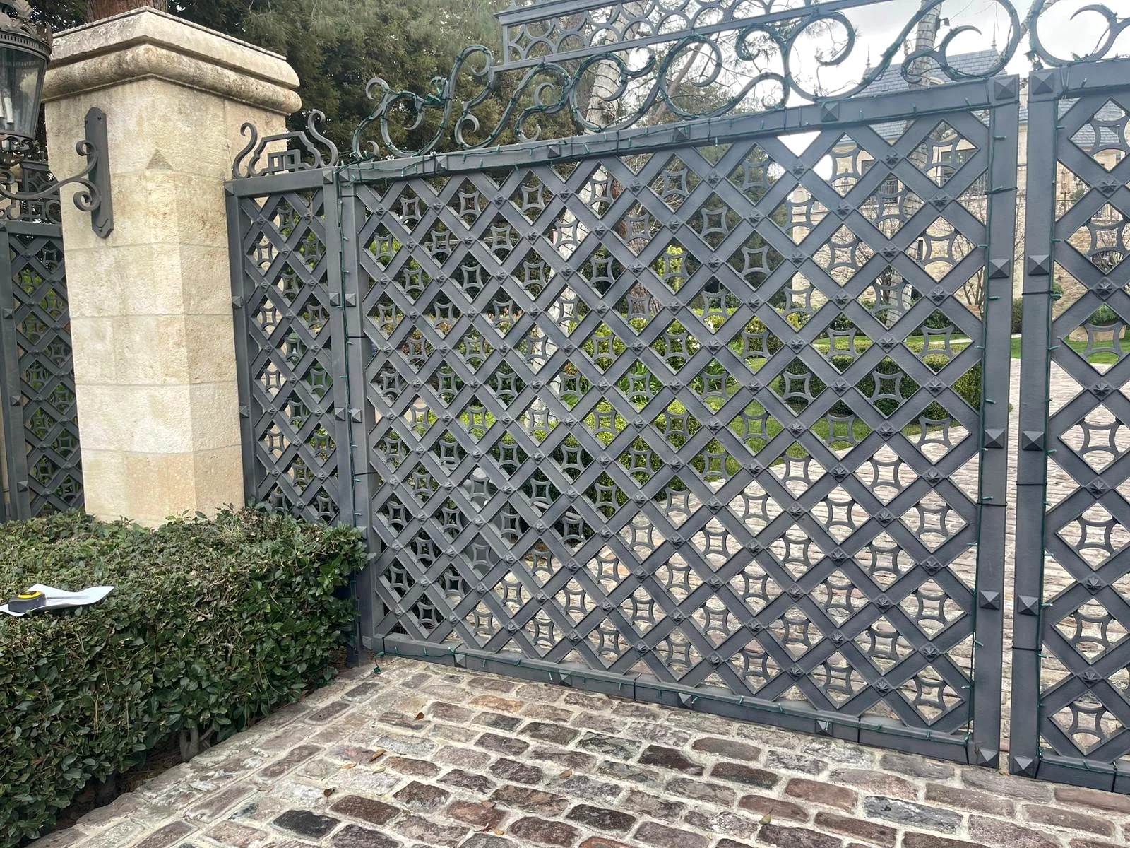 Ornate wrought-metal gate with geometric lattice design